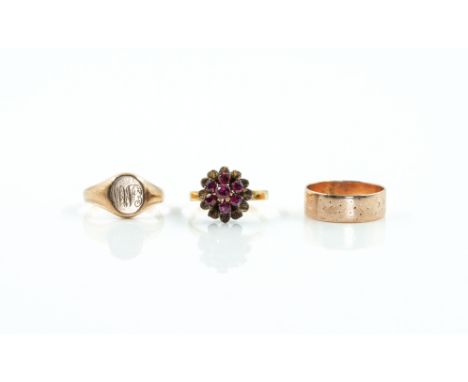 THREE RINGS (3)Comprising; a ruby cluster ring, designed as a flowerhead, ring size N, a 9ct gold wedding ring (mis-shapen) a