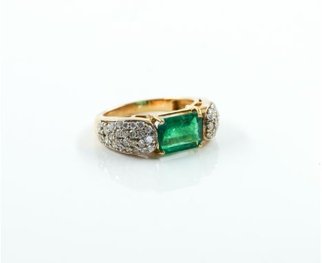 A GOLD, EMERALD AND DIAMOND RINGMounted with the cut cornered rectangular step cut emerald at the centre, between circular cu