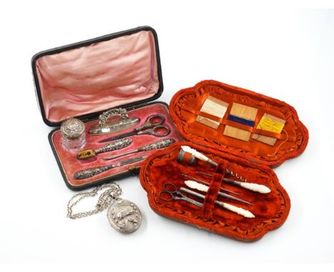 A VICTORIAN SILVER OVAL PENDANT LOCKET WITH A LATER CHAIN AND TWO FURTHER ITEMS (3)The front of the locket decorated with a d