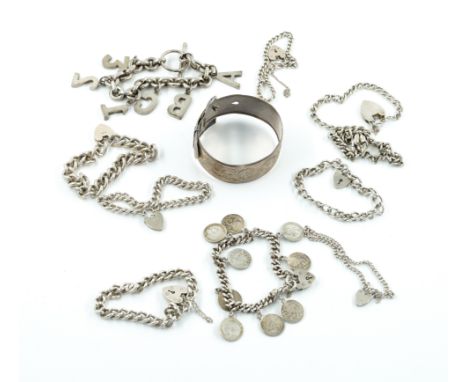 A GROUP OF SILVER JEWELLERY (11)Comprising; a bangle, a coin bracelet, an initial charm bracelet, seven curb link bracelets w