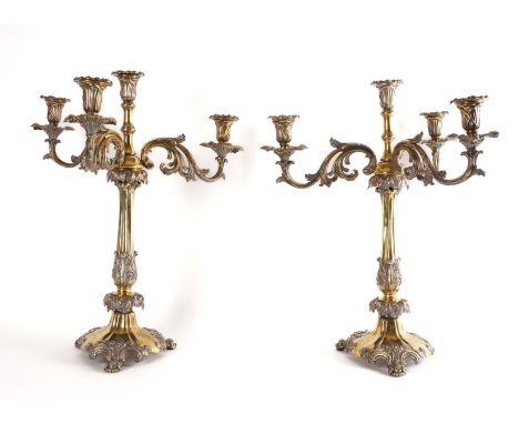 A PAIR OF  VICTORIAN FOUR LIGHT SILVER-PLATED TABLE CANDELABRAParcel gilt, each with scrolling foliate arms and raised on a t