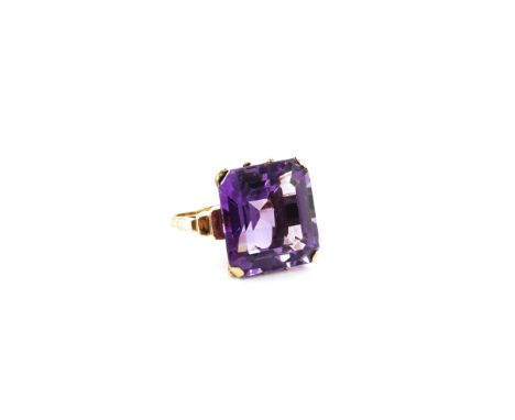 A GOLD AND AMETHYST SINGLE STONE RINGClaw set with a cut cornered rectangular step cut amethyst, detailed 9 CT, ring size L, 