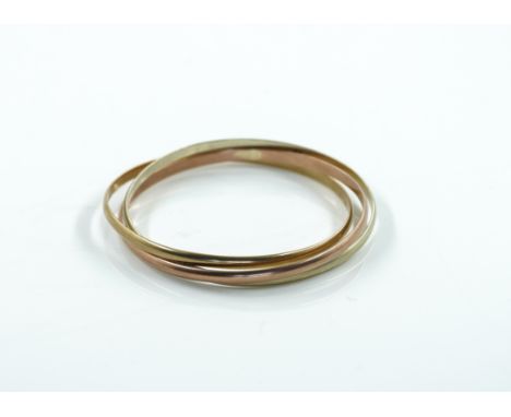 A 9CT THREE COLOUR GOLD RUSSIAN STYLE BANGLEOf circular triple section form, London 1985, weight 26.8 gms