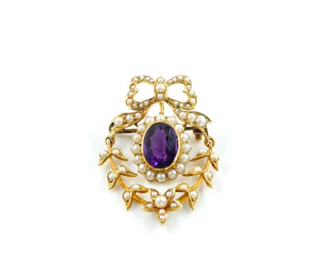 AN EDWARDIAN GOLD, SEED PEARL AND AMETHYST BROOCHCollet set with the oval cut amethyst within a surround of seed pearls, the 