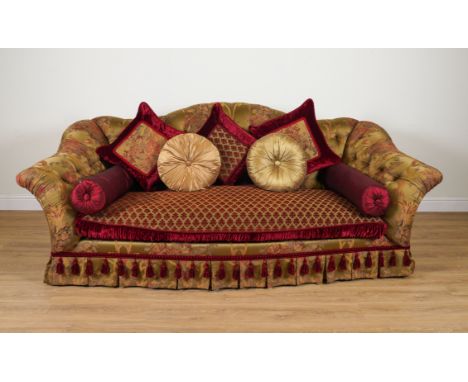 PROVASI: A LARGE GREEN/GOLD FLORAL SILK UPHOLSTERED BUTTON BACK SOFAOf serpentine outline, on turned gilt supports, 265cm wid