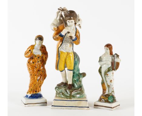 THREE PRATT WARE FIGURES (3)Circa 1800
Each standing on a square base, comprising a figure of `The Lost Sheep', 24cm high; a 