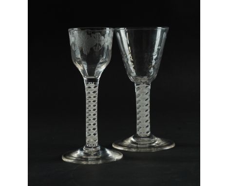 TWO OPAQUE TWIST WINE GLASSES (2)Circa 1765
Each with a double series opaque twist stem, one with ogee bowl engraved with fru