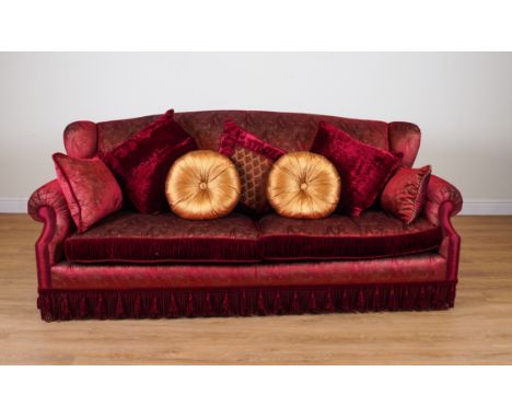 PROVASI: A RED PAISLEY SILK UPHOLSTERED WINGBACK SOFAOn turned gilt supports, 245cm wide; 105cm high