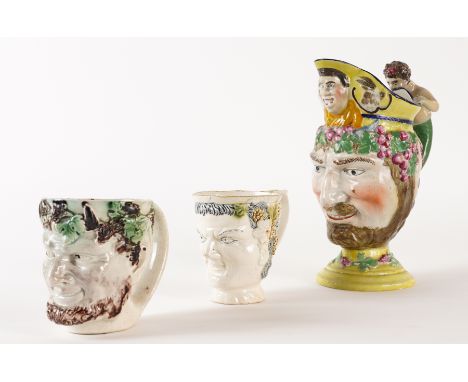 THREE PEARLWARE MASK JUGS (3)Late 18th/early 19th century
One modelled as a satyr with green and manganese glazes, 9.5cm high
