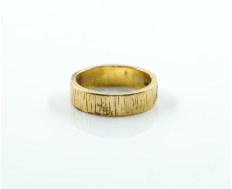 A GOLD WEDDING BAND RINGWith bark textured decoration, detailed 18 CT, ring size K and a half, weight 6 gms, with a case