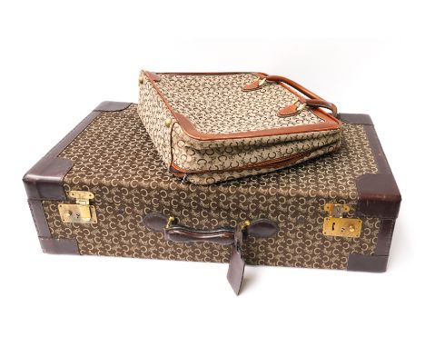 CELINE: A C MACADAM PATTERN SUITCASE AND A CANVAS CARRY CASE (2)Modern
The suitcase in dark brown canvas with dark leather ed