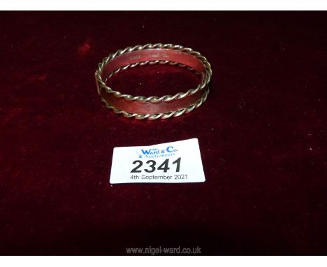A silver Bangle with rope twist design detail.