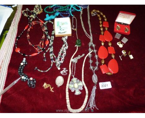 A tin of mixed costume jewellery including magnetic beads and bracelets, New Zealand carved Jade pendant etc.