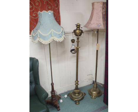 Two converted brass standard lamps and another standard lamp with mahogany base (3) Condition Report: Available upon request