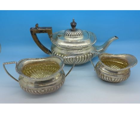 A three piece silver tea service, cream and sugar hallmarked Birmingham 1908, tea pot London 1909, 526g