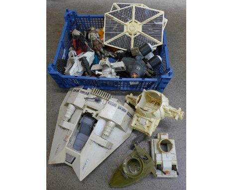 A collection of Star Wars figures and vehicles including vintage