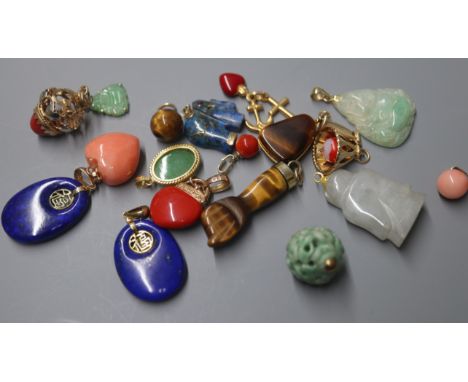 A jade Buddha pendant with 14K gold suspension loop and eighteen other jade and hardstone pendants and charms, various, inclu