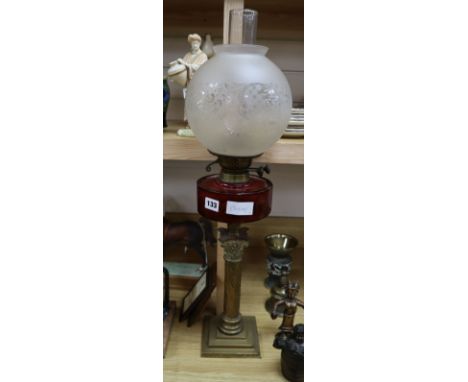 A brass and cranberry glass oil lamp height 70cm