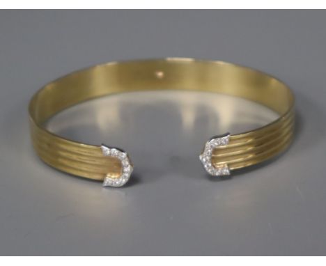 A 9ct. gold and diamond set open bangle.