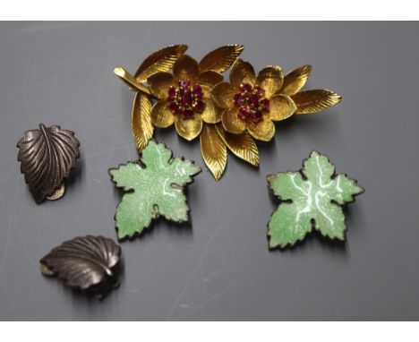 A yellow metal and ruby set leaf brooch and two pairs of white metal earrings including enamel.