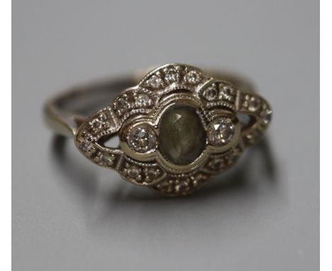 A 750 white metal, aquamarine and diamond set lozenge shaped ring, size K.