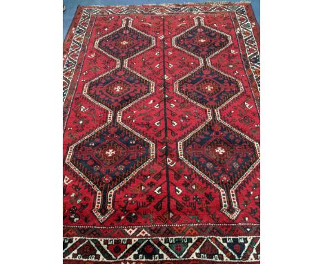 A Belouch red ground carpet 244 x 180cm