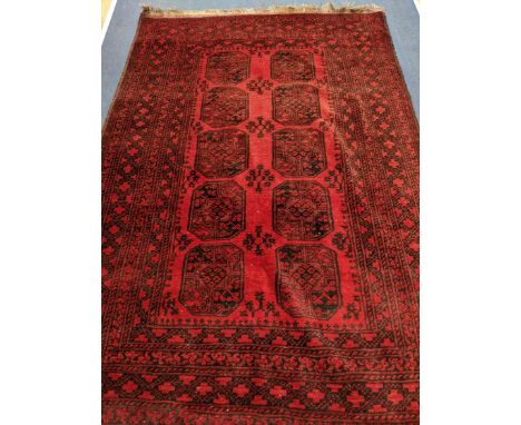 A Belouch red ground carpet 230 x 160cm