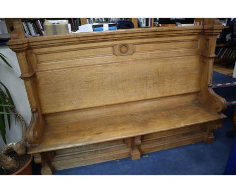 A late Victorian light oak hall seat W.220cm