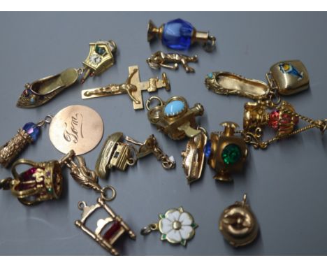 A 9ct gold crucifix pendant and a collection of nineteen 9ct gold charms, various, including a crown, a chair, a lantern, a g