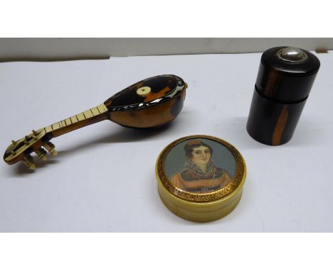 A small Lignum Vitae Bottle Holder with sprung base, 2 1/2" (6cms), a tortoiseshell and bone miniature mandolin, and a tortoi