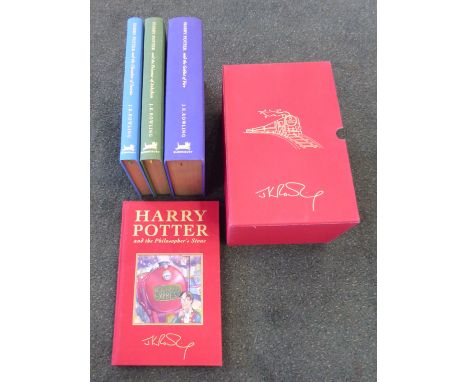 J K Rowling; Harry Potter deluxe edition, four volumes, various printings of the first edition, in a slip case.