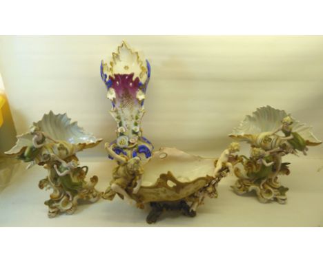 A pair of Austrian shell shape Vases with figures etc.  11" (28cms) high, a similar Austrian boat shape vase and a French Man