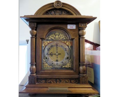 An Edwardian Bracket Clock with German movement, steel and brass dial and in walnut case with fluted pilasters, with a presen