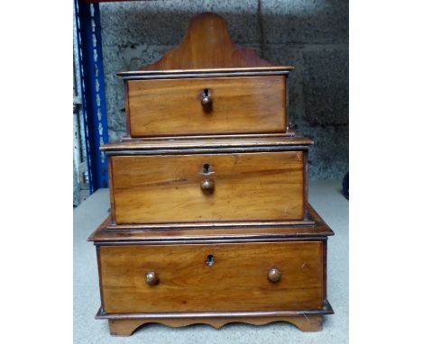 A late 19th Century stained pine three tier Collectors Chest fitted with three drawers on bracket feet.  9 1/2" (24cms) wide.