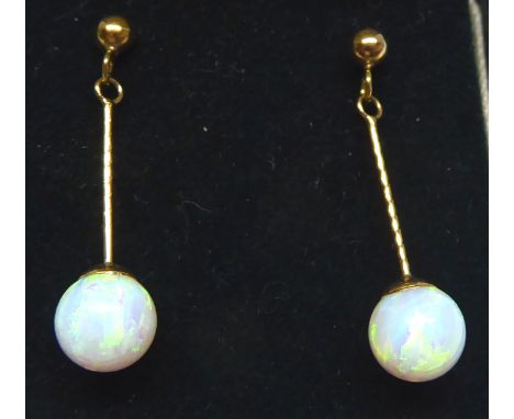 A pair of 9ct. gold pendant Earrings each set with a single opal. 