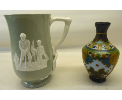 A Copeland Spode Mug decorated with a raised pattern in white of a golfer, the reverse with his caddy and a riding crop handl