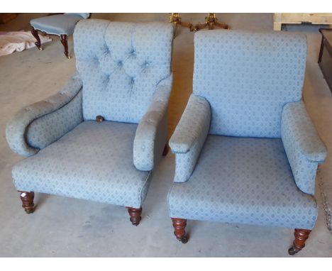 A late Victorian Armchair with button upholstered back and seat, on short turned supports, and another Armchair upholstered t
