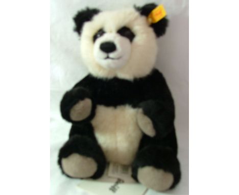 A Steiff Panda no. 010620,  complete with tags, labels, etc., 11" (28cms) high.