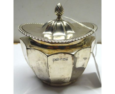 An Edwardian silver oval Tea Caddy of panel sided design with hinged cover, Sheffield 1903, maker: Joseph Rodgers, 5 oz.