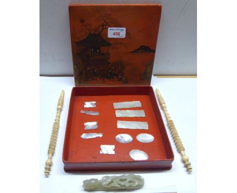 A lacquered Box containing a Jade Belt Hook, a pair of 19th century ivory face screen handles and eleven Chinese mother of pe