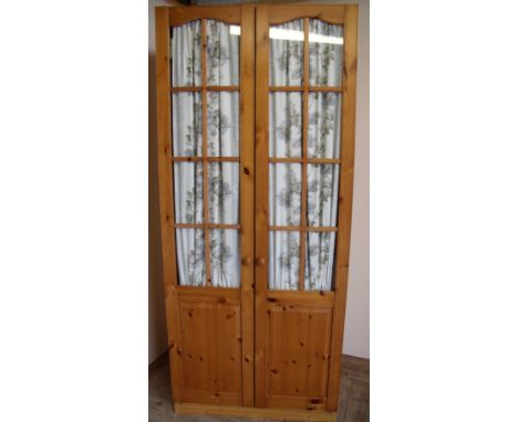 Large modern double door pine wardrobe with single internal shelf and upper glazed doors with panelled detail to the base (89