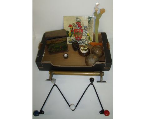 Two iron cannon balls, brass wall mounted hand rail, brass and porcelain light switch on stepped wooden base, 1950's wire coa