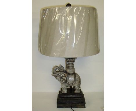 As new table lamp in the form of an elephant on a stack of books with cream shade