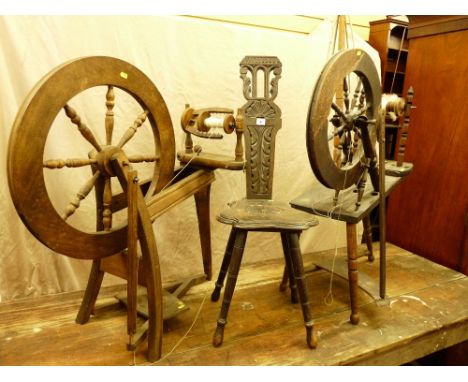 A CARVED SPINNING WHEEL CHAIR and two vintage spinning wheels (as seen)