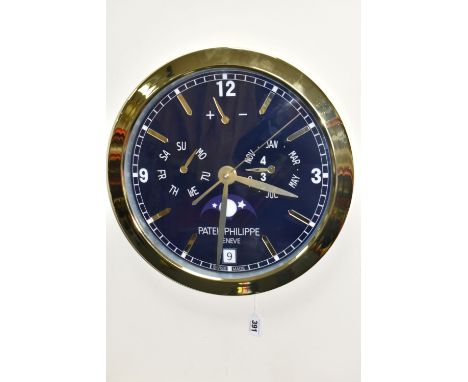 A PATEK PHILIPPE GENEVE DISPLAY CLOCK with printed Arabic numeral timestamps on a blue white face and gold coloured metal fra