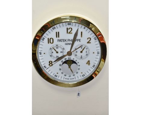 A PATEK PHILIPPE GENEVE DISPLAY CLOCK with printed Arabic numeral timestamps on a printed white face and gold-coloured metal 