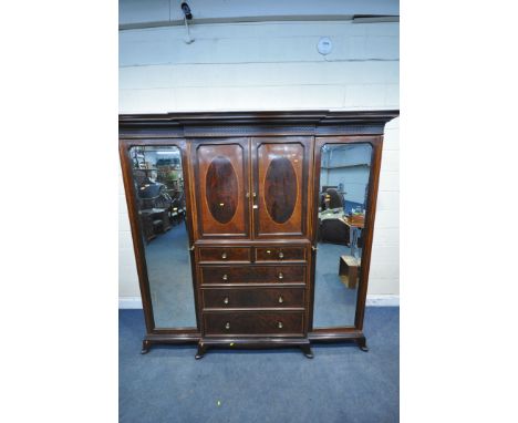 WARING OF OXFORD STREET LONDON, an early 20th century mahogany compactum wardrobe, with two bevelled mirror doors, flanking t