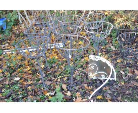 A SELECTION OF GARDEN METALWARE including a set of eight baskets on stands, height 72cm, and a wrought iron corner shelf with