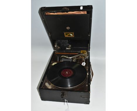 A HMV MODEL 101 PORTABLE WIND-UP GRAMOPHONE, reference number no. 1O1O063796, with 78rpm record storage, four 78s included, s