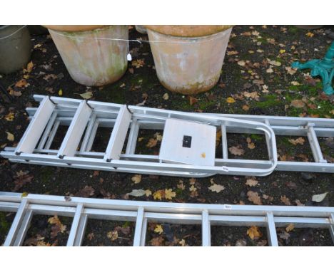 A SHORT ALUMINIUM DOUBLE EXTENSION LADDER with seven rungs to each 200cm section and a step ladder (2)